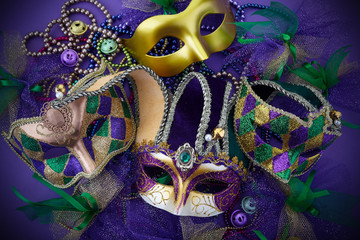 Mardi gras, venetian or carnivale mask on a purple background. Top view