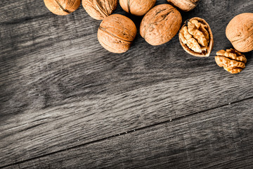 Whole walnuts on dark board, Walnut kernels in wood rustic bowl. top view nut photo