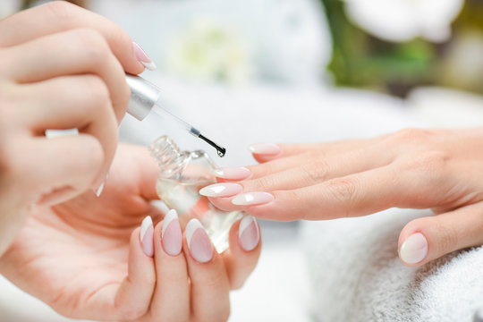 Manicure nail paint with thin brush on colour background,Nails artist polish, modelation gel