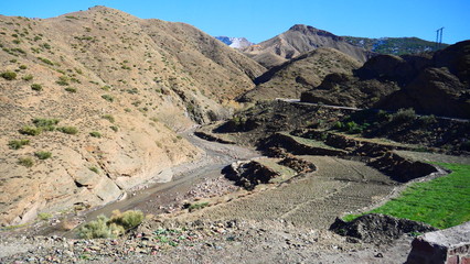 Bright landscape of Morocco, breathtaking curves of mountains, stunning combination of hills & farm land,inadvertent distribution of houses & huts, raw impression of pure nature.