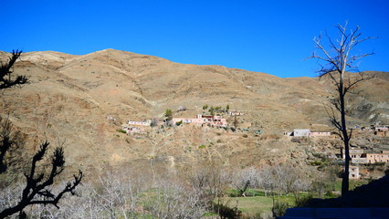 Bright landscape of Morocco, breathtaking curves of mountains, stunning combination of hills & farm land,inadvertent distribution of houses & huts, raw impression of pure nature.