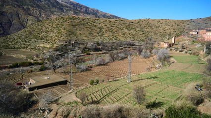 Bright landscape of Morocco, breathtaking curves of mountains, stunning combination of hills & farm land,inadvertent distribution of houses & huts, raw impression of pure nature.