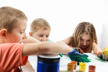 children paint with hands drawing lesson at school