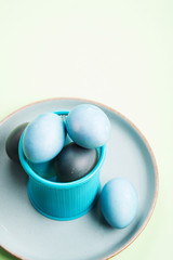 Blue easter eggs on pastel green background