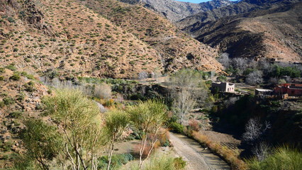 Bright landscape of Morocco, breathtaking curves of mountains, stunning combination of hills & farm land,inadvertent distribution of houses & huts, raw impression of pure nature.