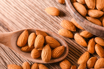 Almond nuts on wooden table top view. Fresh almonds copy space.