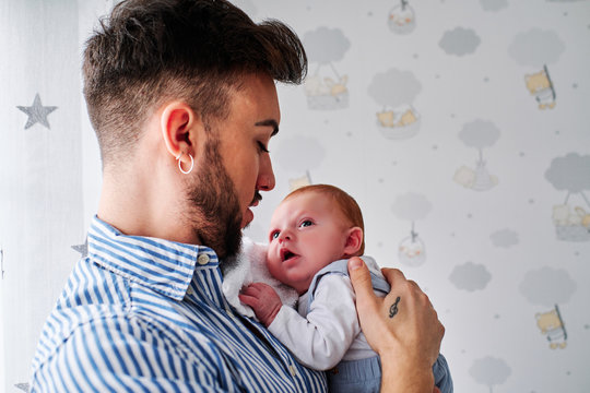 A Young Father Taking Care Of A Newborn