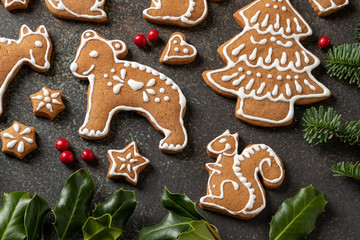 Homemade Christmas gingerbread cookies with fir and holly
