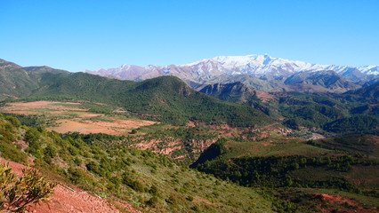 Fototapeta na wymiar Bright landscape of Morocco, breathtaking curves of mountains, stunning combination of hills & farm land,inadvertent distribution of houses & huts, raw impression of pure nature.