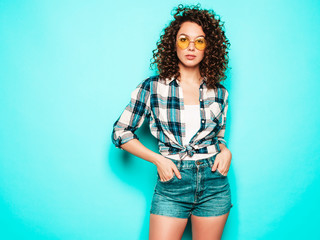 Portrait of beautiful smiling model with afro curls hairstyle dressed in summer hipster...