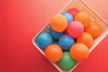 Close up of multi color ball on red background