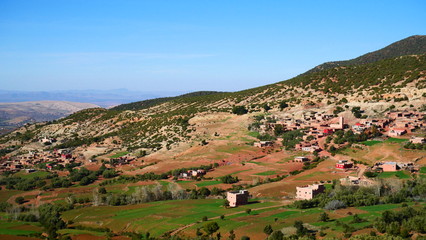 Bright landscape of Morocco, breathtaking curves of mountains, stunning combination of hills & farm land,inadvertent distribution of houses & huts, raw impression of pure nature.