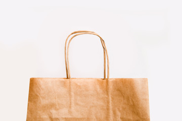 paper craft shopping bag made of recycled paper on a white background copy space. edge of the paper bag