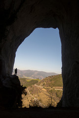man inside a cave in basque country, spain