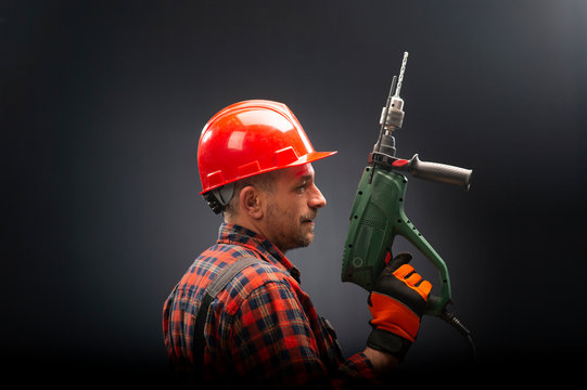 Electrical worker with a pneumatic drill presses