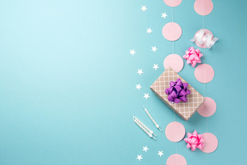 Happy Birthday concept. Blue festive table with gift, candles and other decorations top view. Space for text.