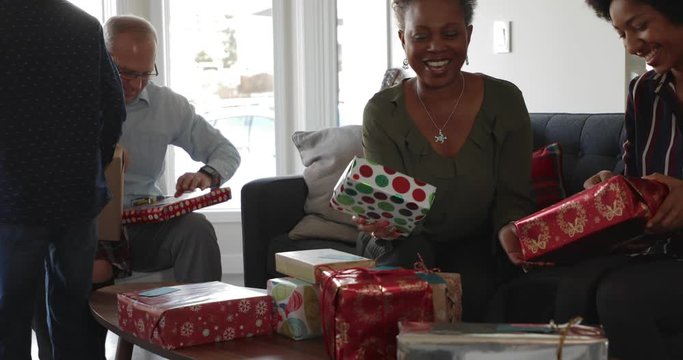Multi-ethnic multi-generation family opening Christmas gifts
