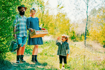 Family planting. Family Gardeners. Smile family on farmland. Earth day. © Volodymyr