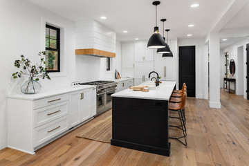 Fototapeta Beautiful white kitchen with dark accents in new modern farmhouse style luxury home obraz