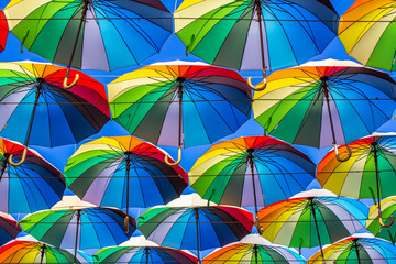 Colorful umbrellas Blue, green, red, rainbow umbrellas background Street with umbrellasin the sky...