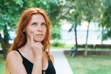 Pensive girl in park. Concept of problem of choice.