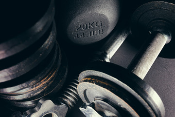 Close up of bunch of free weights and kettlebell in corner