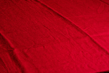 Background in the form of bright red crumpled fabric. Diagonal lines