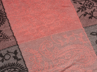 Fragment scarf with black patterns on a gray background. Diagonal location