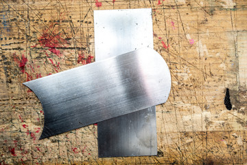 Pair of Cabinet  or card scrapers  on wooden workbench grunge stained surface. Simple and effective...