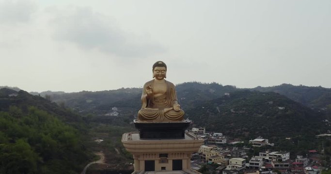 Fo Guang Shan, Aerial pan left in front of large golden Buddha statue in biggest temple in Taiwan, near Kaohsiung