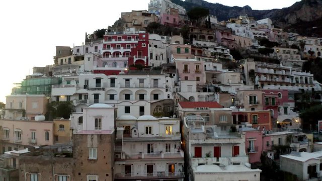 Aerial, reverse, drone shot away buildings and Campanian architecture, in the Positano village, on the Amalfi coast, in Salerno, southern Italy