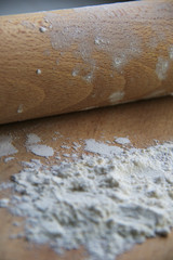 flour on wooden board and rolling pin