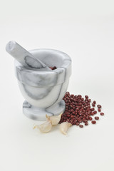 The portrait of still life Marble mortar and pestle red bean and garlic on the white background