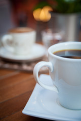 Caffee on table and blured cafe