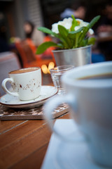 Caffee on table and blured cafe