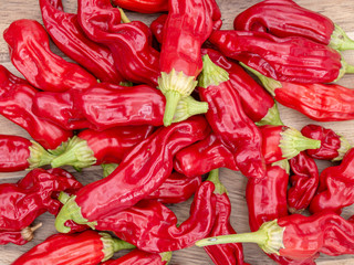 Bunch of red Bhut Jolokia chili on wooden background