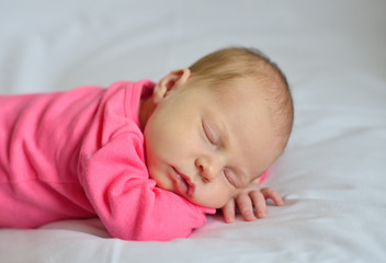 baby sleeping on the bed