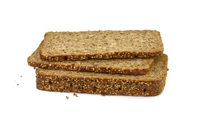 Slices of wholemeal dark bread isolated on a white background in close-up (high details)