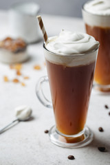 Iced coffee in a tall glasses with cream poured over