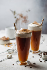 Iced coffee in a tall glasses with cream poured over