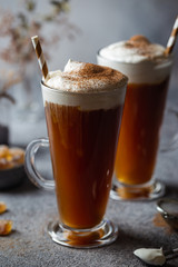 Iced coffee in a tall glasses with cream poured over