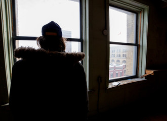 Man in shadowy window