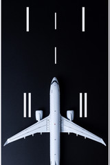 Passenger plane model on runway, Top view. Concept of summer journey, airline safety, security and traveling insurance