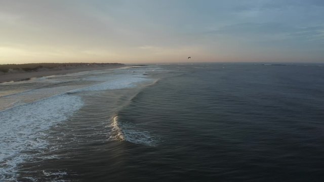 Aerial backwards shot over Ofir beach misty lights, North Portugal - Slow motion