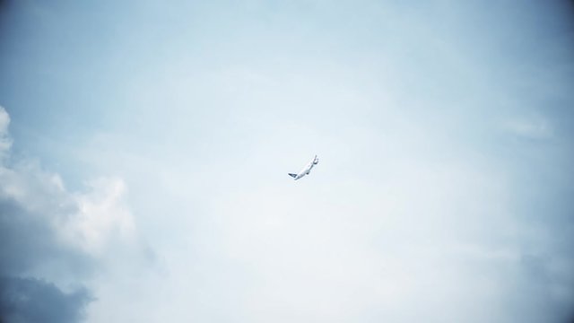 Big passenger plane in the blue sky. Takeoff. A general plan. Aerobatic figures. Airshow. 17 seconds