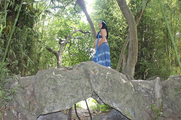 Fototapeta na wymiar pregnant woman sitting on a tree