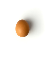 Brown chicken egg on a white background, flat lay, isolate