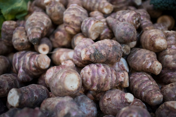 Fresh pink Jerusalem artichoke in box for sale in the market