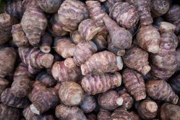 Fresh pink Jerusalem artichoke in box for sale in the market