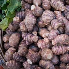 Fresh pink Jerusalem artichoke in box for sale in the market